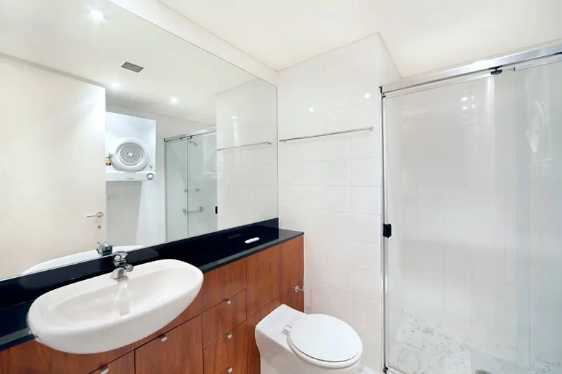 Bathroom with walk-in shower and vanity at The Peninsula, Balmain