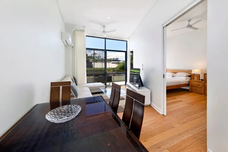 Open-plan living and dining area opening to the balcony in the Balmain residence