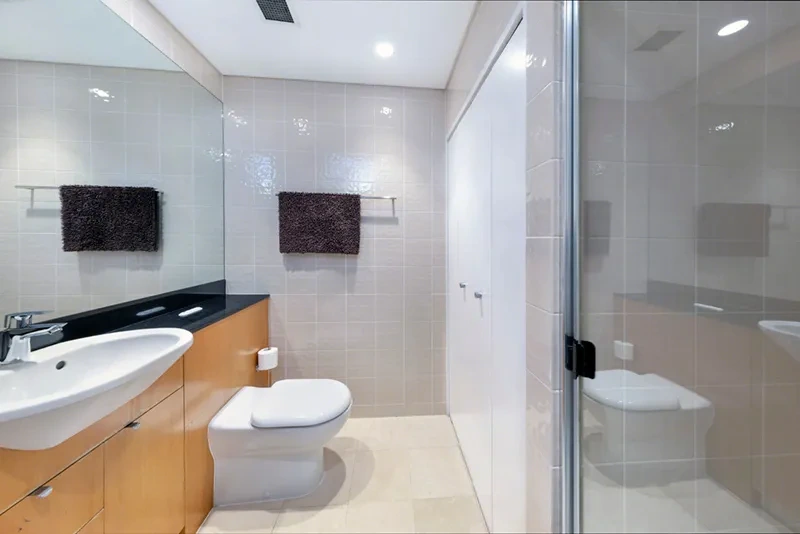 Bathroom with walk-in shower and vanity at The Peninsula, Balmain
