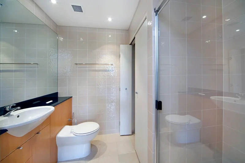 Bathroom with walk-in shower and vanity at The Peninsula, Balmain