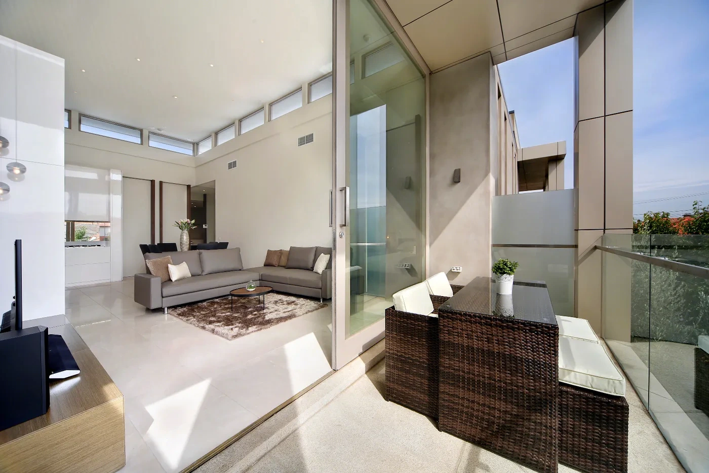 Open-plan living opening to the balcony at a Westprecinct serviced residence in Brighton