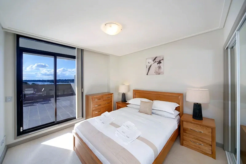 Comfortable furnished bedroom with water outlook