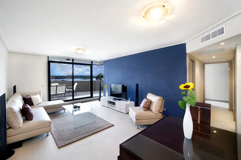 Contemporary open-plan living area with water outlook