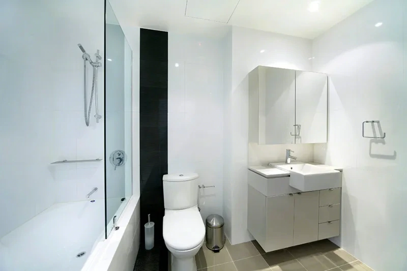 Bathroom with walk-in shower and vanity at the Wentworth Point residence